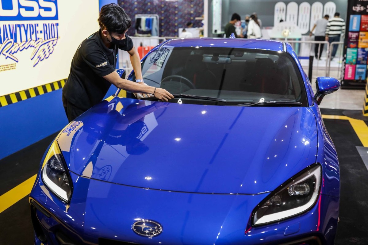 A Subaru BRZ in blue at a car show, getting a detail