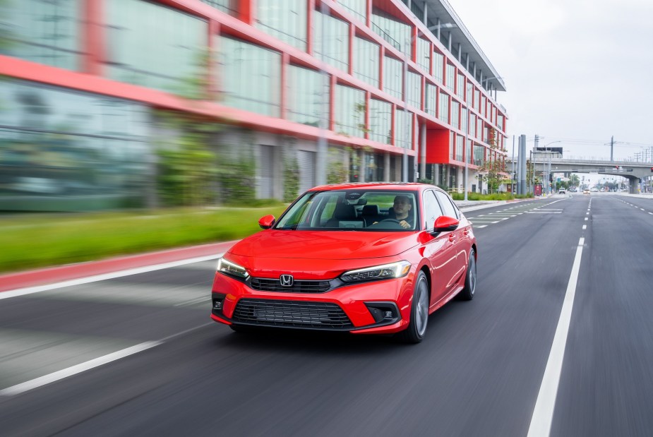 The 2023 Honda Civic shows off its compact car proportions while it blasts over urban streets. 