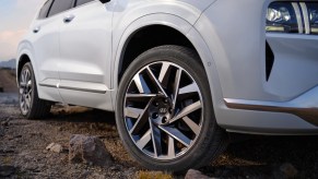 A white Hyundai Santa Fe, which is one of the best midsize plug-in hybrid SUVs parked outdoors.