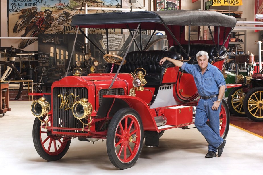 Jay Leno besides the 1907 1908 White Steam car under which he would later suffer severe burns.