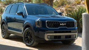 A blue 2023 Kia Telluride midsize SUV is parked.