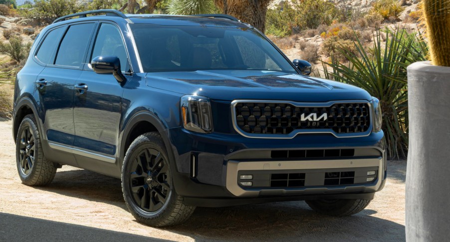 A blue 2023 Kia Telluride midsize SUV is parked.