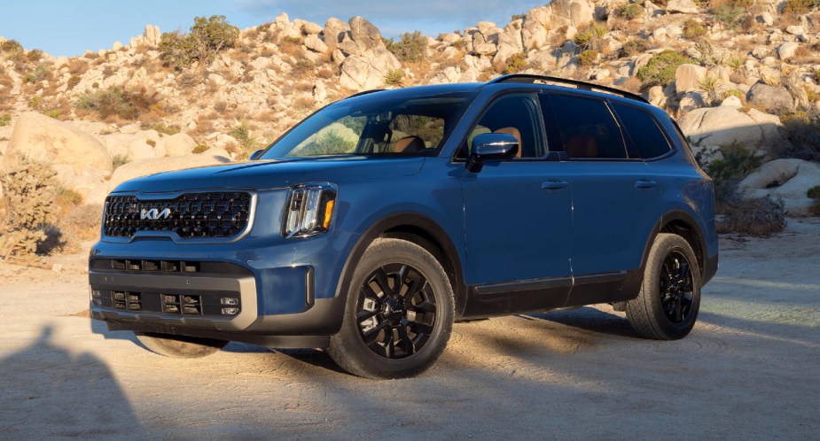 A blue 2023 Kia Telluride midsize SUV is parked. 