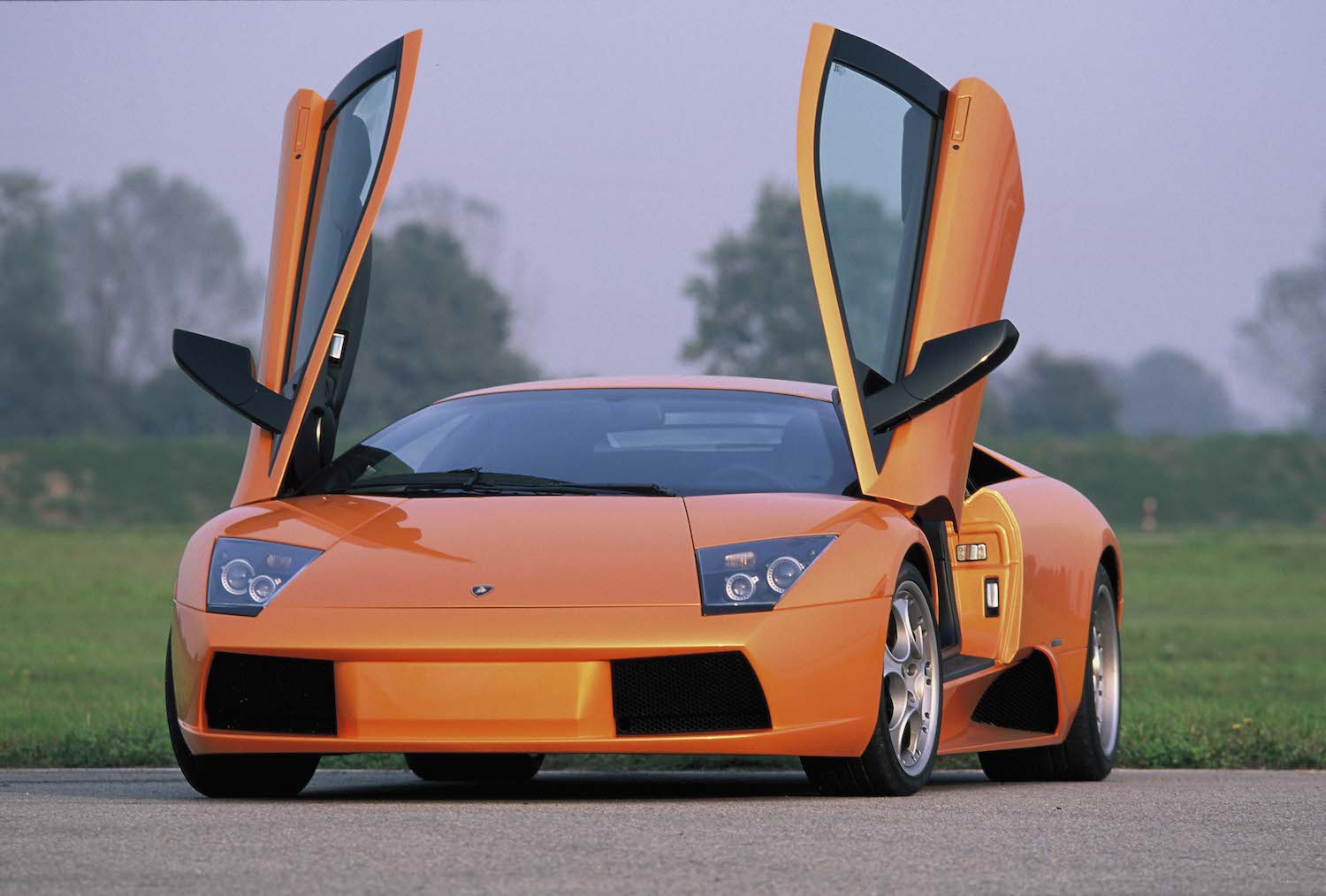 This orange Lamborghini Murcielago supercar would lose a race to 60 MPH to a Rivian electric pickup truck