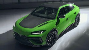 A green Lamborghini Urus SUV is parked.