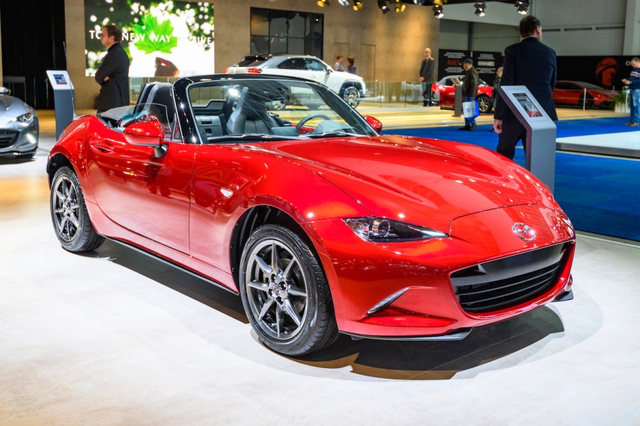 A red Mazda MX-5 Miata, which is one of the least expensive Mazdas to maintain.