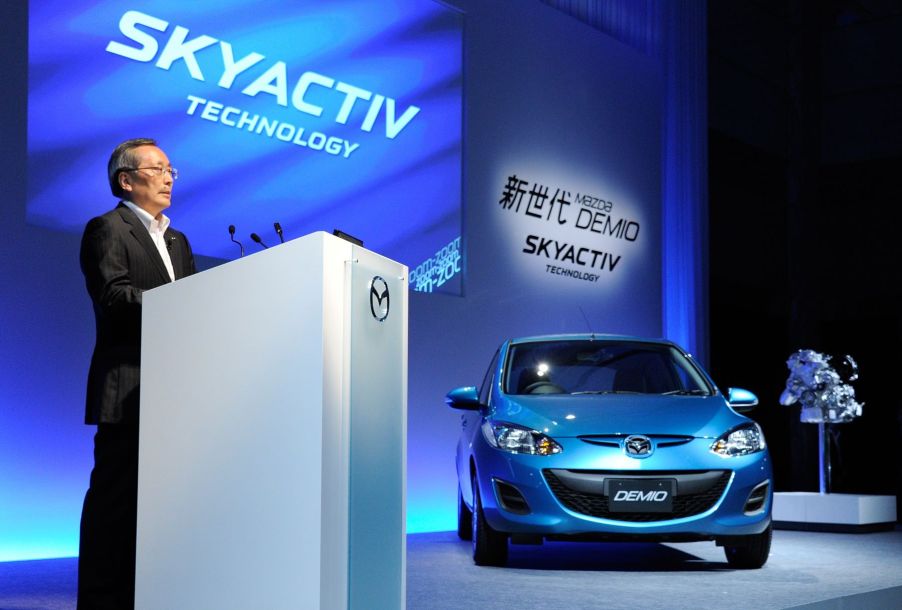 A Mazda conference in Tokyo, Japan, showcasing the Demio car equipped with the SKYACTIV-G 1.3 engine