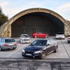 Generations of BMW M3 models near a hangar