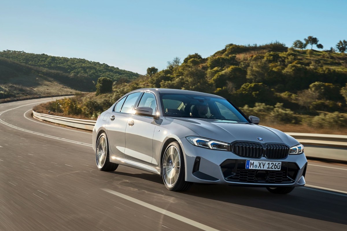 A gray BMW 3 Series on a curved road