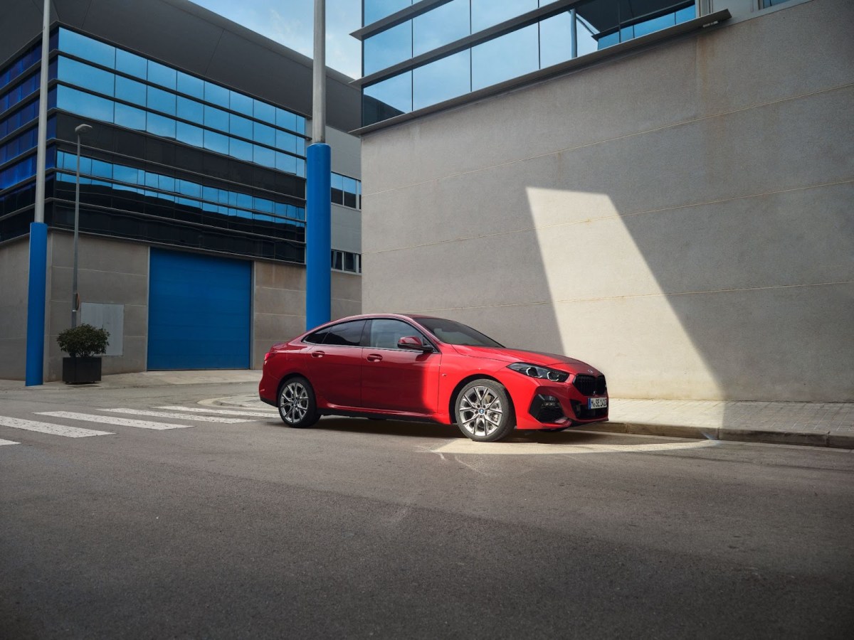 A red BMW 2 Series Gran Coupe parked in a city.