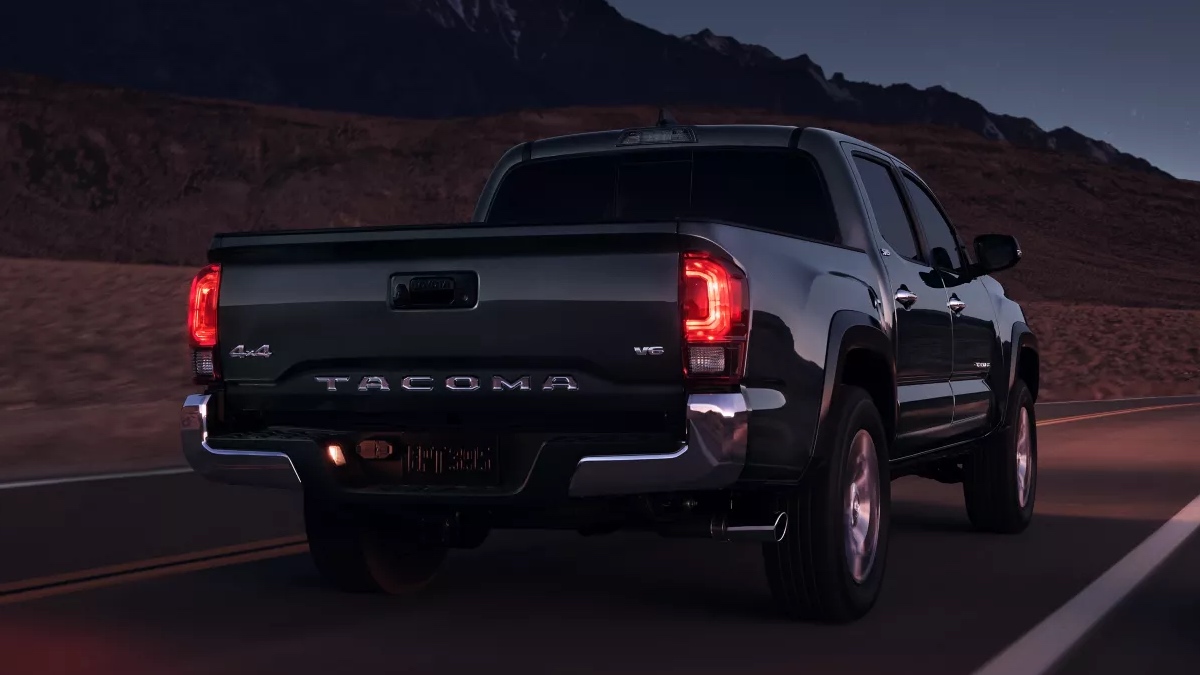 Rear angle view of black 2023 Toyota Tacoma midsize pickup truck