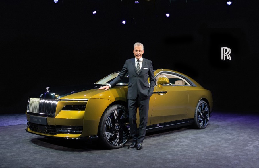 The CEO of Rolls-Royce standing next to a Rolls-Royce model