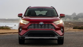 A red 2019 Toyota RAV4 Hybrid small hybrid SUV is parked.