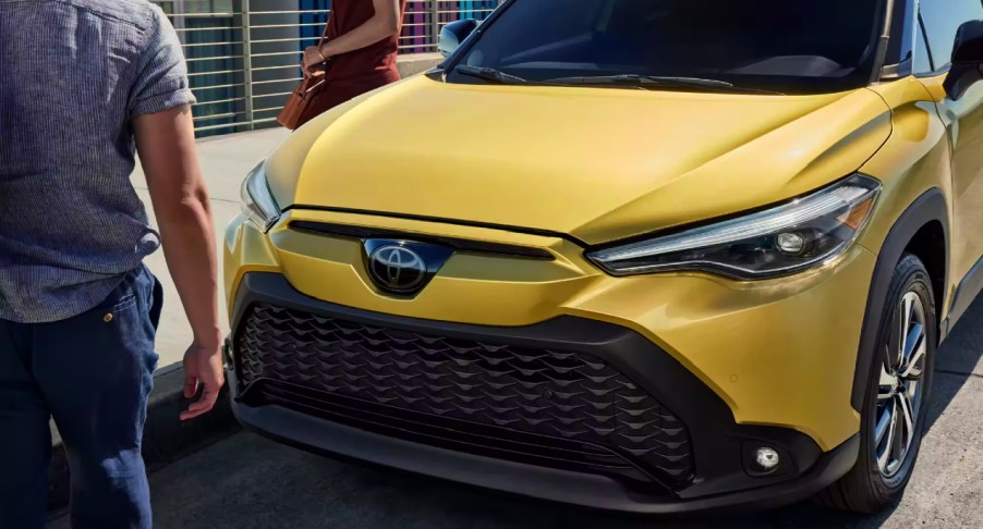 The front of a gold 2023 Toyota Corolla Cross Hybrid.