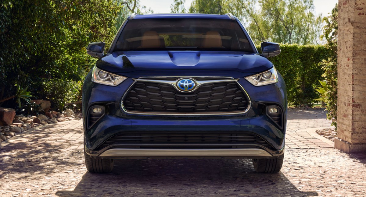 A blue Toyota Highlander Hybrid midsize SUV is parked.