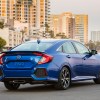 A used Honda Civic shows off its four-door car styling on a beach.