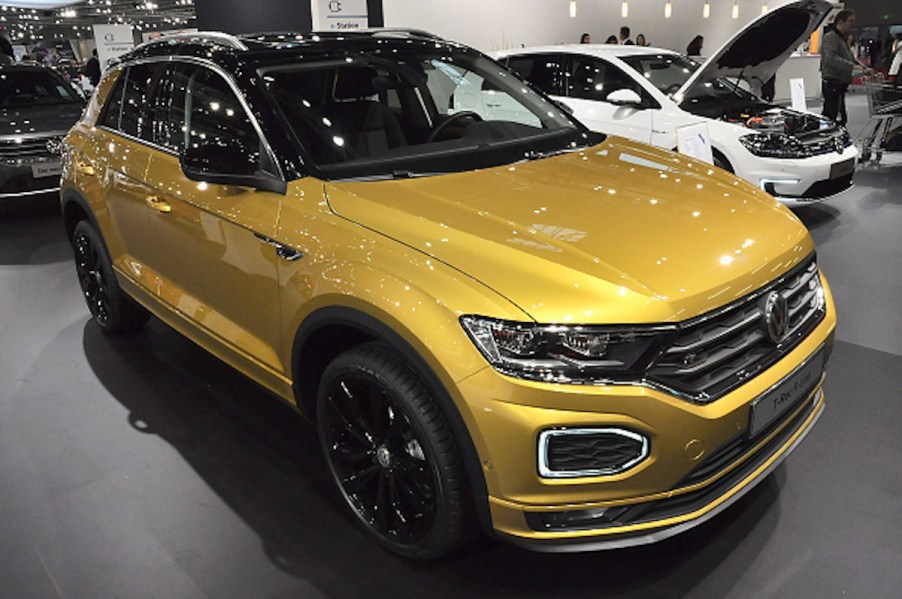 A gold Volkswagen T-Roc as one of the most reliable Volkswagen models parked indoors.