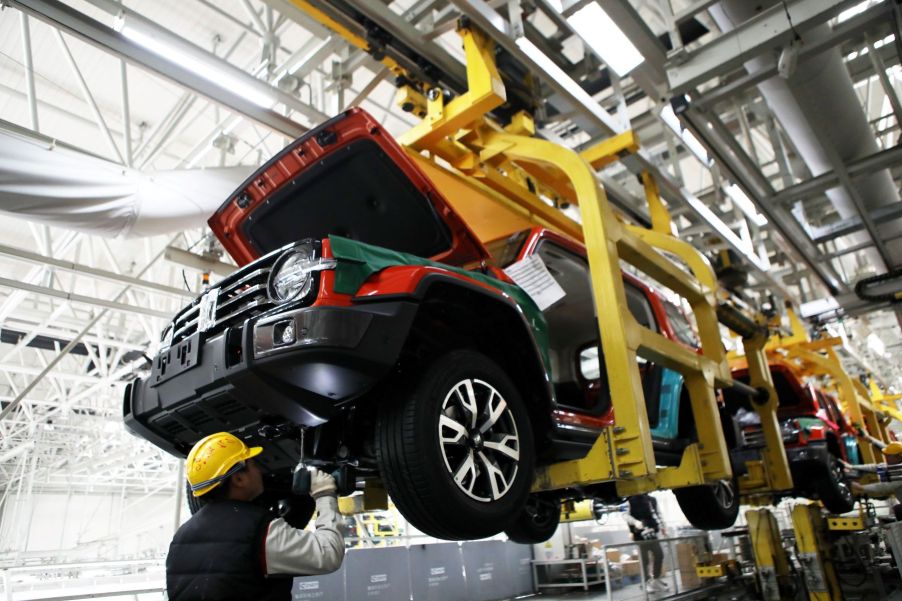 The assembly of a WEY Tank 300 SUV and its undercarriage and transfer case at Great Wall Motors