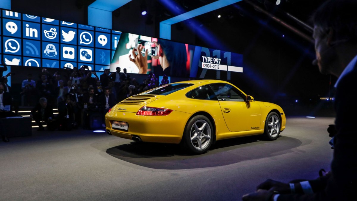 A yellow 997 Porsche 911 at an auto show.