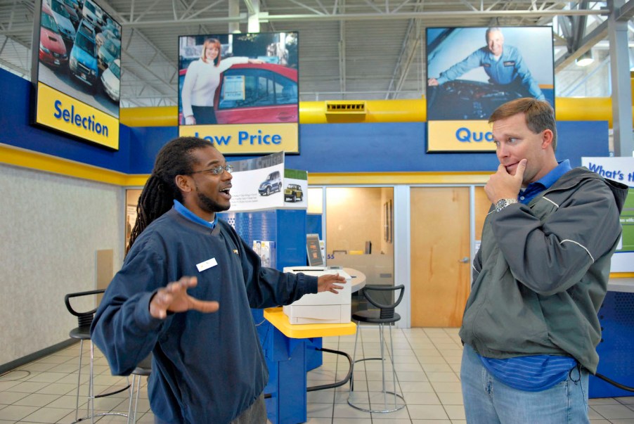 A CarMax sales person talks to a customer