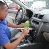 A man cleaning the interior of a car.