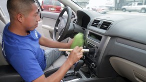 A man cleaning the interior of a car.