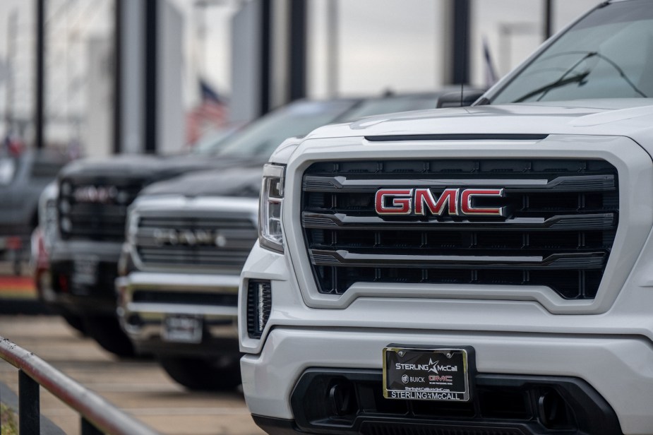 Closeup of the dealership license plate holder surround on a GMC SUV.