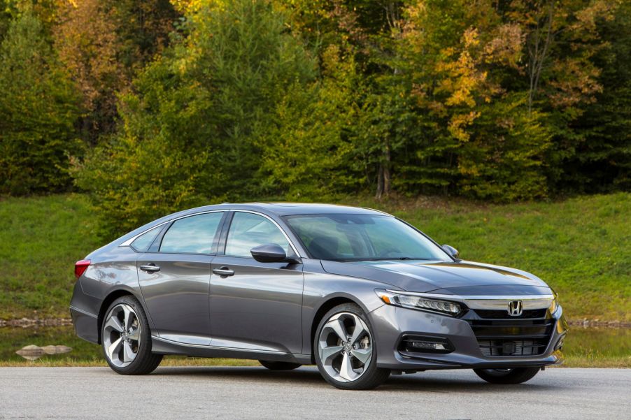 A gray 2019 Honda Accord midsize sedan model with a background of forest trees