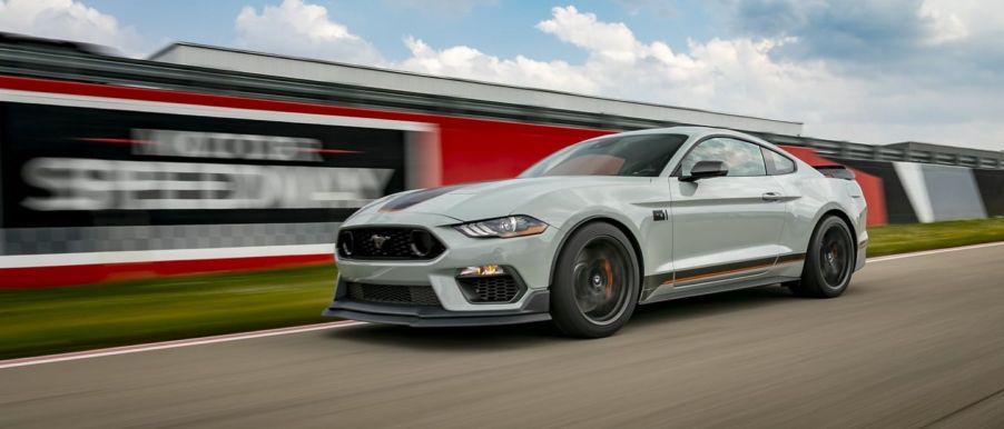 A 2023 Ford Mustang muscle car racing on a motor speedway