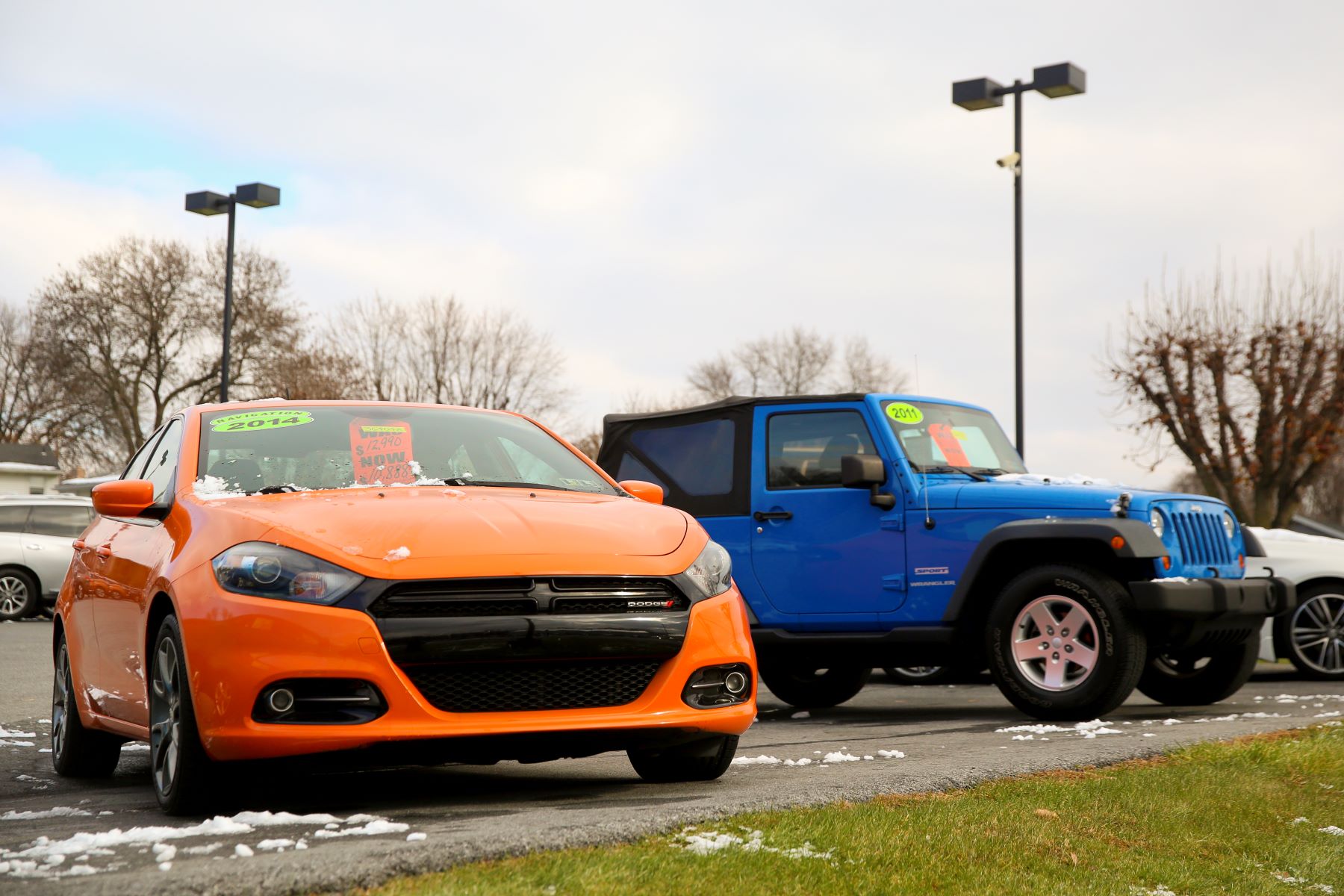 An orange used 2014 Dodge Dart compact sedan model for sale at the Eisenhauer Nissan dealership