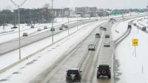 People driving during winter on a highway.