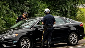 Highway patrol officers pull a car over.