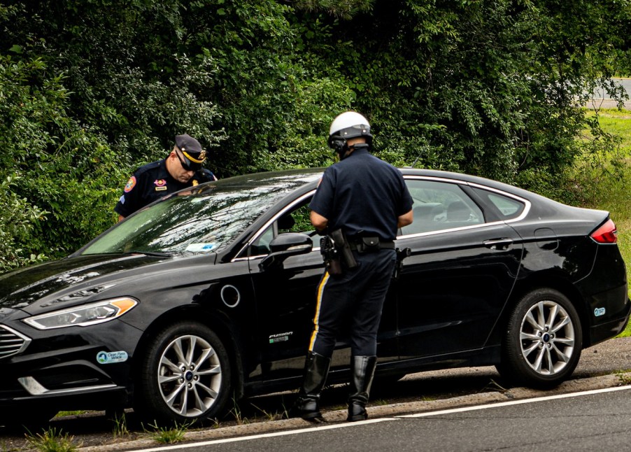 Highway patrol officers pull a car over.