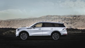 Spacious midsize luxury SUVs like this 2023 Lincoln Aviator parked in front of a mountain