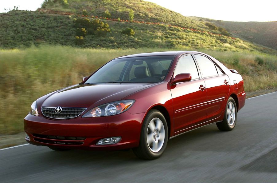 A red 2002-2006 generation Toyota Camry SE midsize sedan model