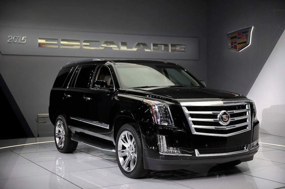 A black 2015 Cadillac Escalade parked indoors. 