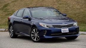 A dark blue 2016 Kia Optima parked outdoors.