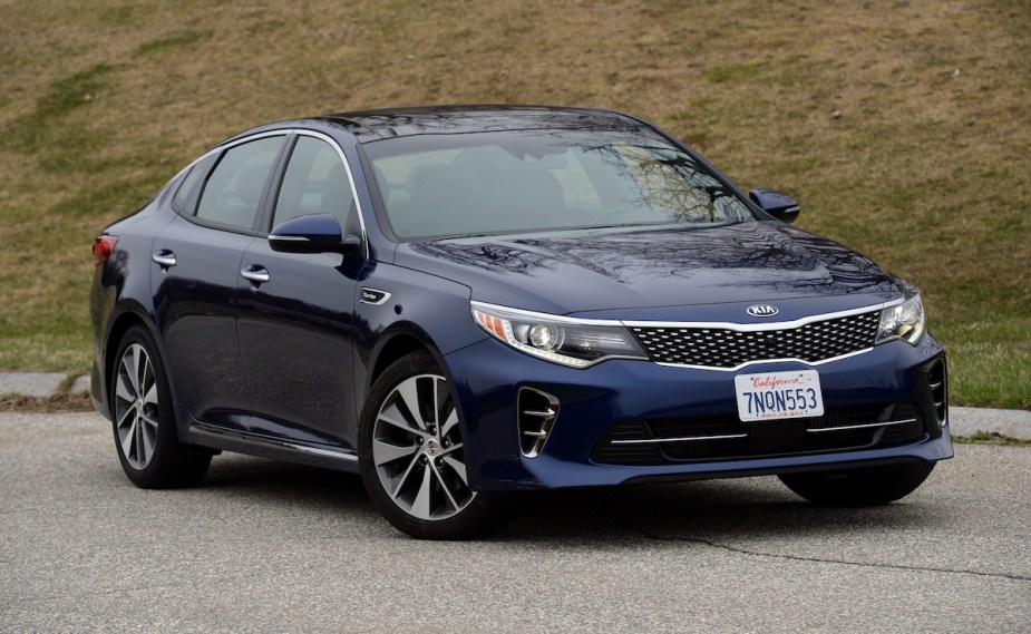 A dark blue 2016 Kia Optima parked outdoors. 