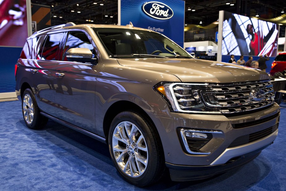 A gold 2018 Ford Expedition parked indoors. 