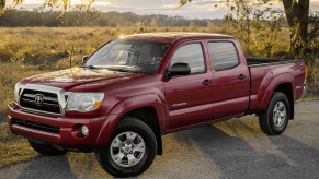 A red 2018 Toyota Tacoma parked under a tree