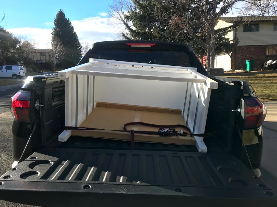 2022 Hyundai Santa Cruz with a dresser loaded into its bed.