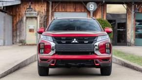 A red 2022 Mitsubishi Outlander Sport sitting in a drive way.