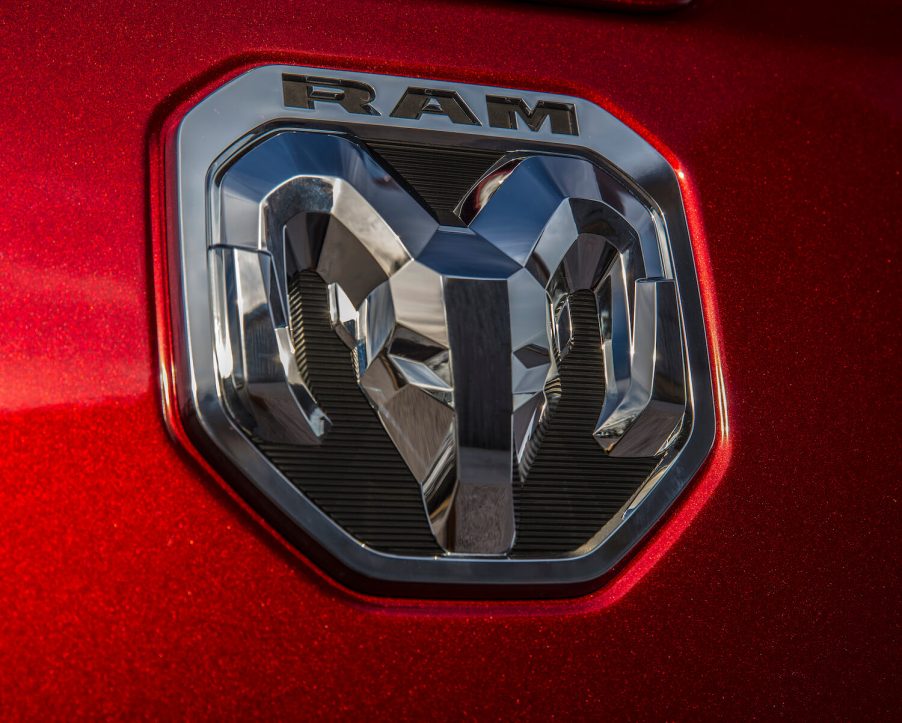 The chrome logo on the tailgate of a Ram pickup truck.