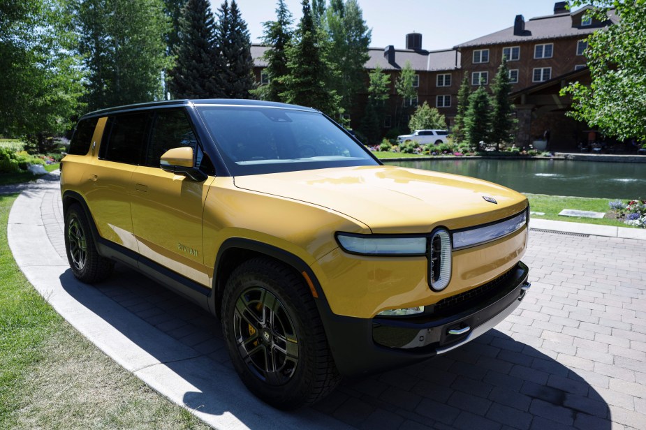 A yellow 2022 Rivian R1S parked outdoors. 