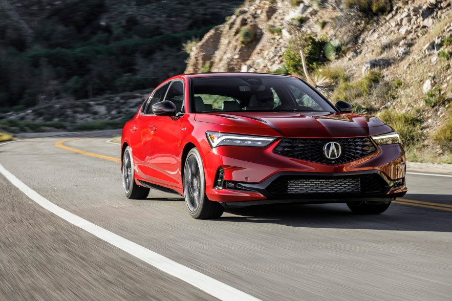 The Acura Integra's looks are an apparent sibling for a 2023 Honda Civic as it corners on a mountain road.