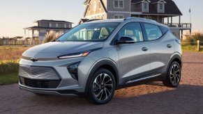 A gray 2023 Chevrolet Bolt EUV subcompact electric SUV is parked on the sand.