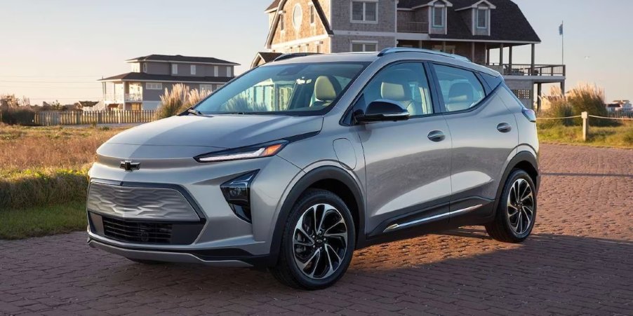 A gray 2023 Chevrolet Bolt EUV subcompact electric SUV is parked on the sand.