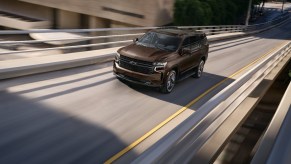 A brown 2023 Chevy Tahoe LT driving on a highway, what are the standard features?