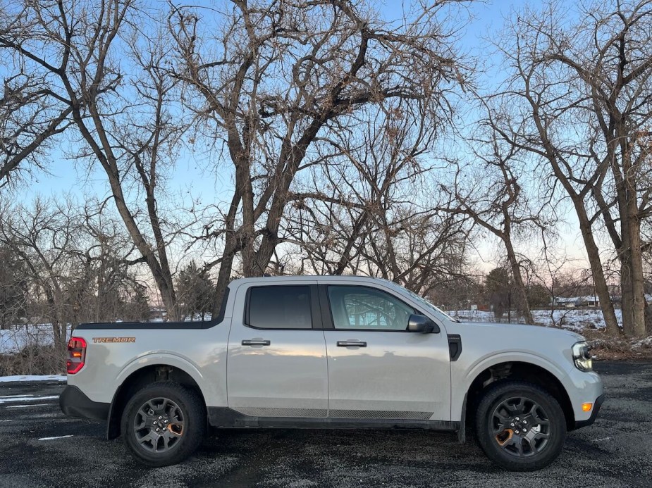 A Ford Maverick Tremor sits in front of a snowy field as a small truck.