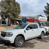 2023 Ford Maverick Tremor in front of a house with a moving truck